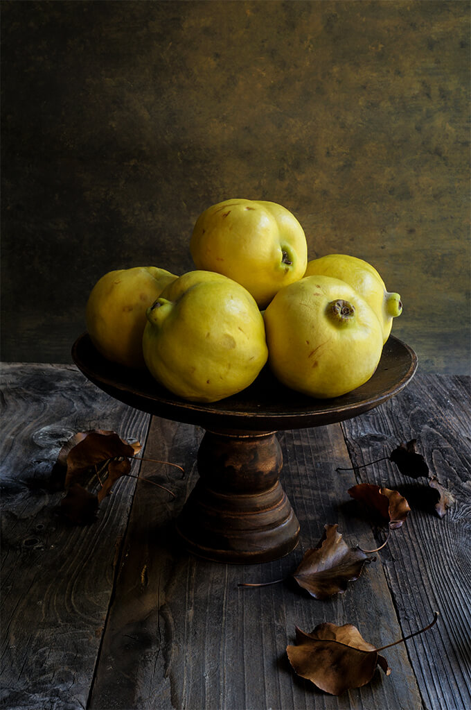 Slow-roasted quinces with ricotta and pistachios. With their intoxicating floral aroma, and soft, melt-in-your-mouth sweet flesh, these slow-roasted quinces, topped with honey ricotta, and pistachios are sure to become your favorite fall dessert recipe! | www.viktoriastable.com