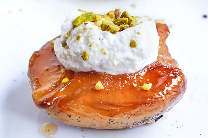 Slow-roasted quinces with ricotta and pistachios. With their intoxicating floral aroma, and soft, melt-in-your-mouth sweet flesh, these slow-roasted quinces, topped with honey ricotta, and pistachios are sure to become your favorite fall dessert recipe! | www.viktoriastable.com