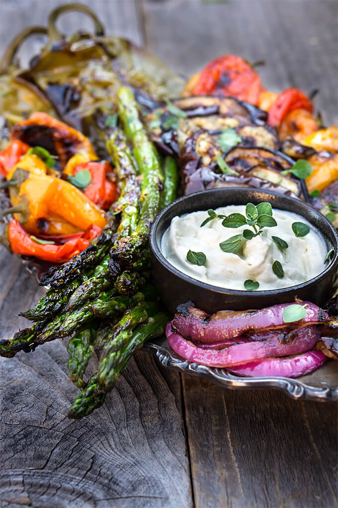 Marinated grilled vegetables with whipped goat cheese - eggplants, peppers, zucchini, asparagus, and onions, marinated and grilled till soft on the inside and charred on the outside, then doused in garlicky marinade, and served with whipped goat cheese on the side. | www.viktoriastable.com
