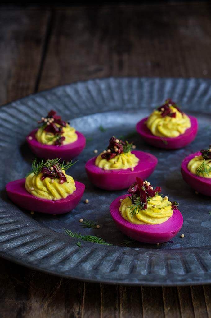 Beet-pickled curry deviled eggs - pickled in beet marinade for a gorgeous magenta color, then stuffed with a delicious curry filling, they make a spectacular appetizer, and a great way to utilize those leftover Easter eggs. | www.viktoriastable.com
