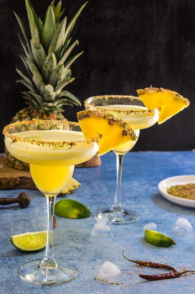 Spicy pineapple margarita - icy-cold, with a spicy kick, fruity and refreshing, served with fragrant chili lime salt, this drink will give you just the right amount of heat and freshness. | www.viktoriastable.com