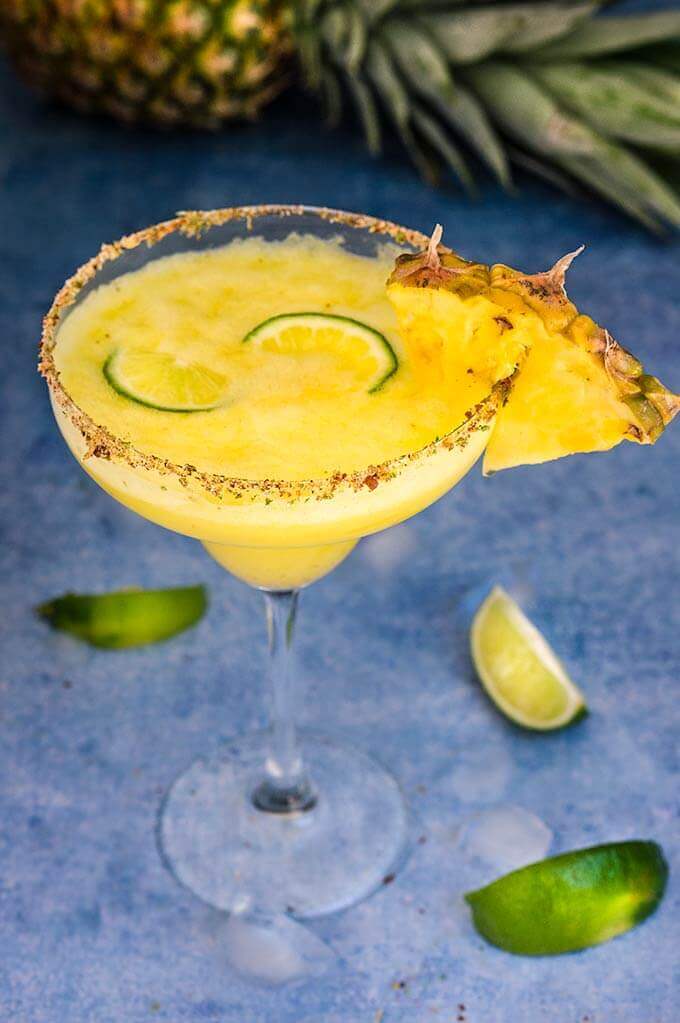Spicy pineapple margarita - icy-cold, with a spicy kick, fruity and refreshing, served with fragrant chili lime salt, this drink will give you just the right amount of heat and freshness. | www.viktoriastable.com