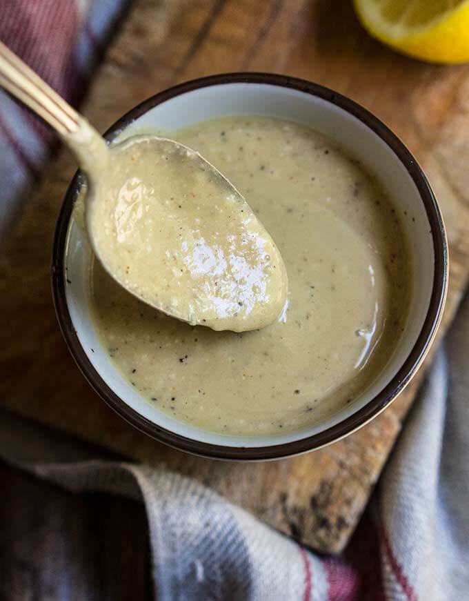 Creamy low fat Caesar salad dressing - healthy Caesar dressing which is packed with protein, low in fat, yet creamy and robust in flavor. | www.viktoriastable.com